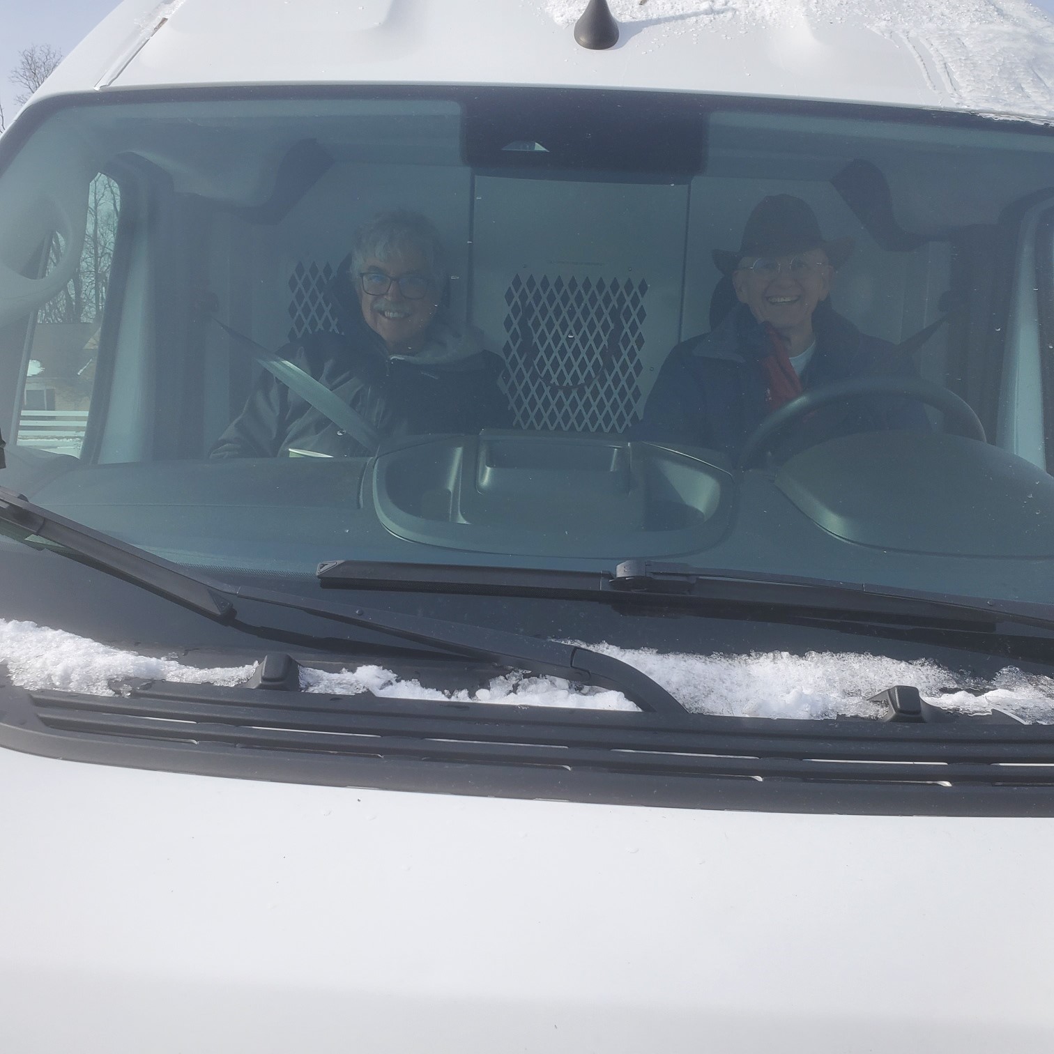 Mark Tucker drives the van while Doug Roberts co-pilots.